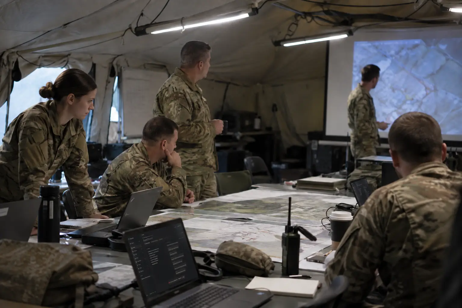 Personnel reviewing documents around a planning table